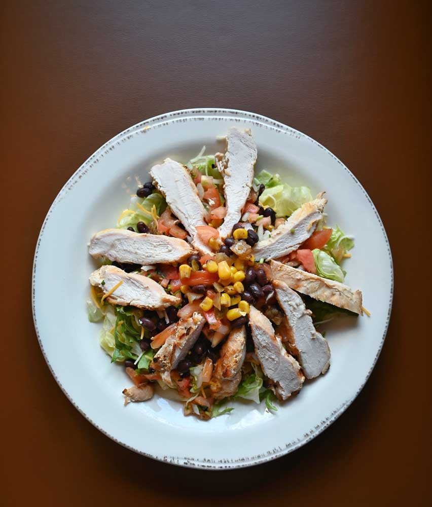 Fresh chicken salad with corn, beans, lettuce, cheese and more. Served by Mackinaws Grill & Spirits in Green Bay WI.