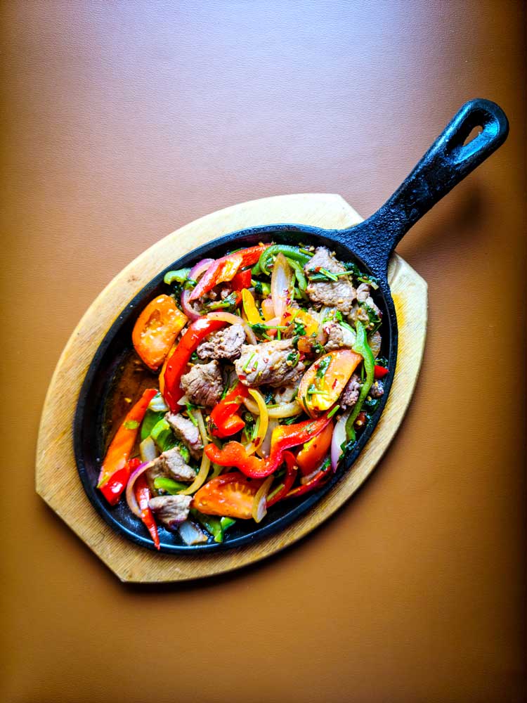Delicious sizzling fajita served by Mackinaws Grill & Spirits in Green Bay WI.