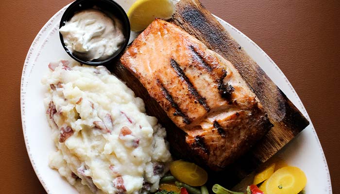 Brining you flakey salmon and steaming mashed potatoes by Mackinaws Grill & Spirits in Green Bay WI.